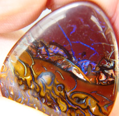 big untreated Australian bolder opal in trillion shape with flower like natural color structures