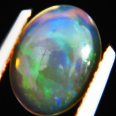 untreated crystal fire rainbow colored oval water welo opal in flat cabochon half single