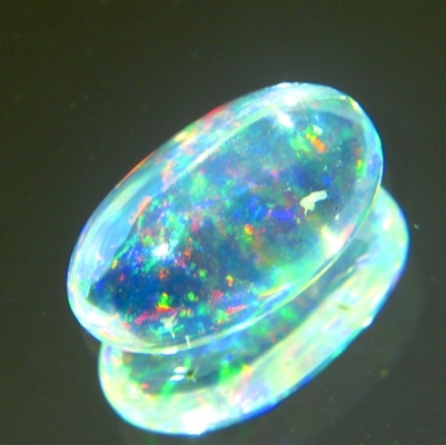 untreated rainbow colored welo opal oval cabochon