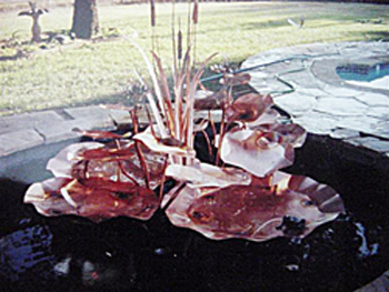 Outdoor copper water garden fountain with Lilies and cat tails
